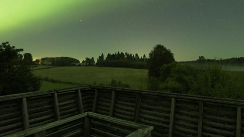 Green aurora over foggy fields — Stillmotion