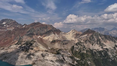 Snowy mountain range and alpine lake — Stillmotion
