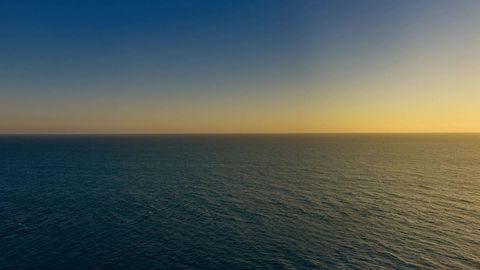 Coastal cliffs over ocean at sunset — Stillmotion