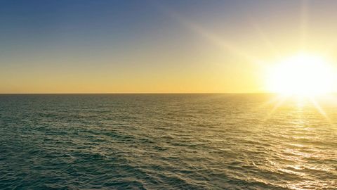 Cliffs over calm sea at sunset — Stillmotion