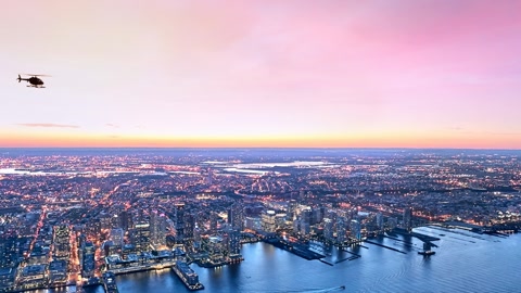 Aerial cityscape over river at sunset — Stillmotion
