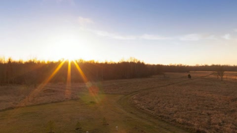 Open hayfield at sunset — Stillmotion