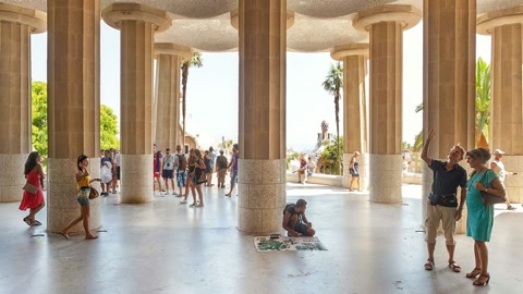 People exploring columned interior hall — Stillmotion