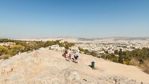 Rocky overlook above city and trees — Stillmotion