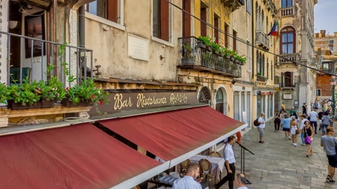 Historic city square with canal and pedestrians — Stillmotion