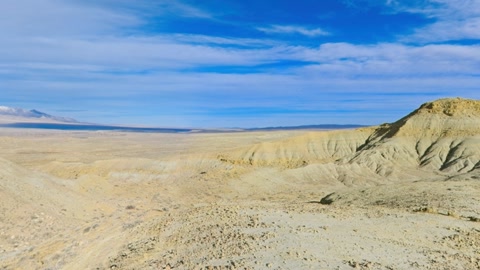 Eroded badlands ridges under blue sky — Stillmotion