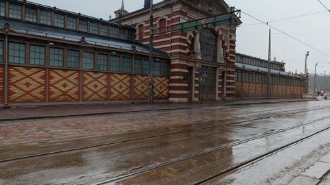Wet street beside restaurant and tram tracks — Stillmotion