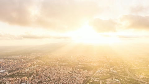 Aerial view of sprawling city and hills — Stillmotion