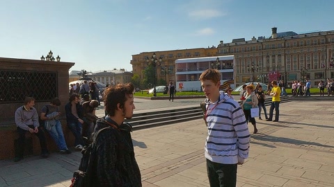 People walking along city promenade — Stillmotion