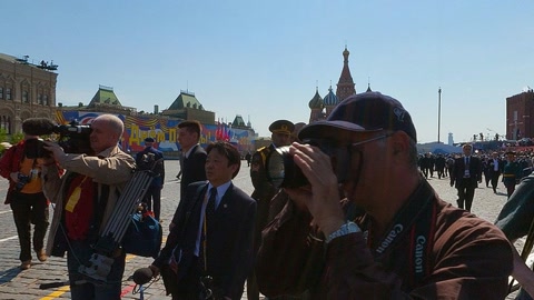 Crowded plaza with military parade — Stillmotion
