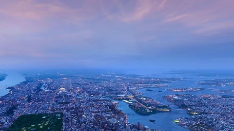 Aerial cityscape over river at sunset — Stillmotion
