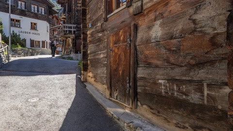 Stone village street with wooden chalets — Stillmotion