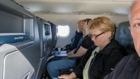 Airplane cabin with passengers and wing view — Stillmotion