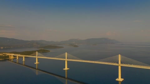 Bridge over calm water at sunset — Stillmotion