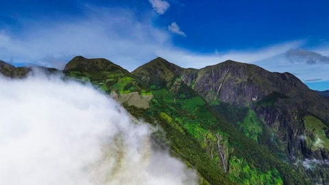 Cloud-covered mountain ridges under blue sky — Stillmotion