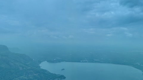Cloudy volcanic mountains and lake — Stillmotion