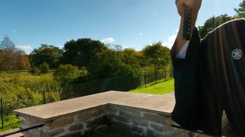 Man in black robes with sword in ruins — Stillmotion