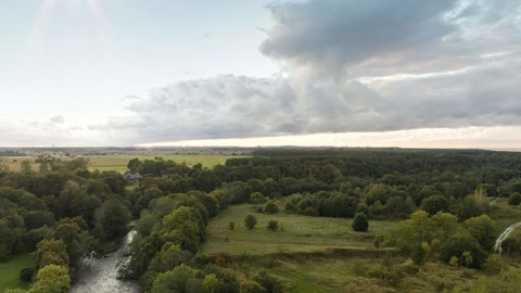 Wooded countryside under cloudy skies — Stillmotion