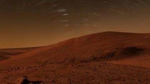 Night desert dunes under star trails — Stillmotion