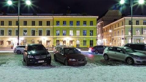Snow-covered city square at night — Stillmotion