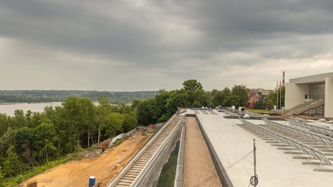 Construction site near river under clouds — Stillmotion