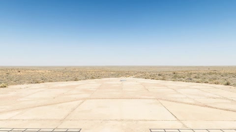 Sandy desert plain with visitor area — Stillmotion