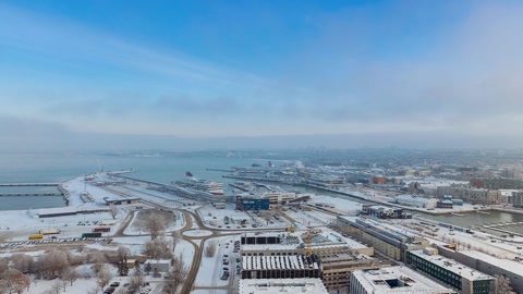 Snowy coastal city skyline and harbor — Stillmotion