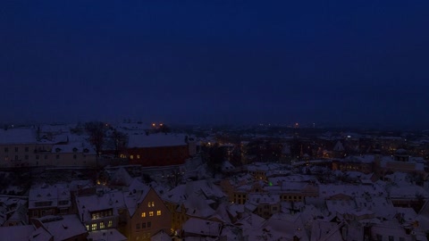 Snow-covered city skyline at night — Stillmotion