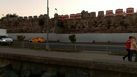 Seaside road along stone fortress wall — Stillmotion