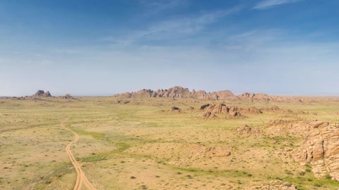 Rocky hayfield under blue sky — Stillmotion