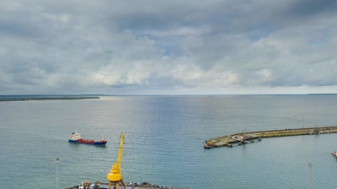 Cargo ships in cloudy harbor — Stillmotion