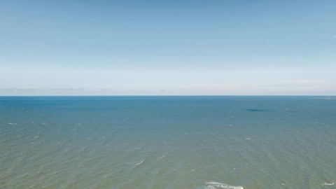 Coastal waters and forested shoreline — Stillmotion