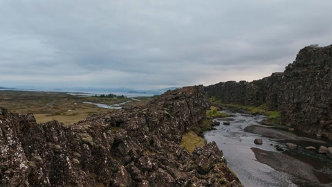 Rocky cliff above a stream — Stillmotion