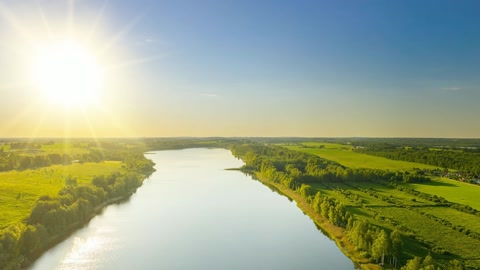 Green countryside beside winding river — Stillmotion