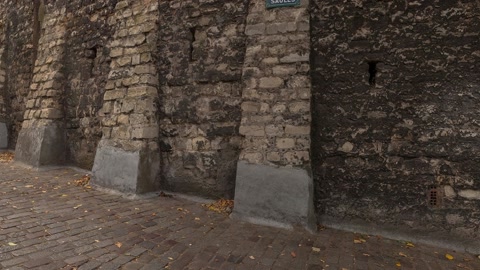 Cobblestone street beside old stone walls — Stillmotion