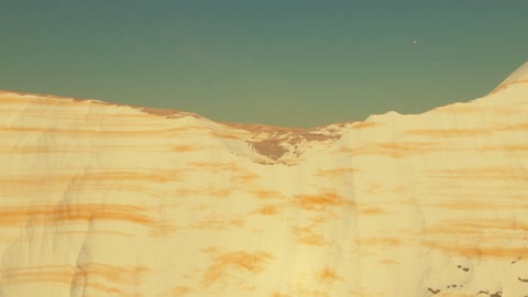 Layered badlands cliffs at sunset — Stillmotion