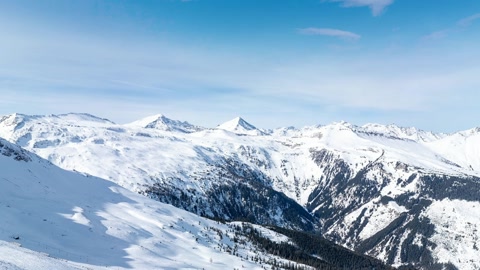 Snowy mountain ridges under clear sky — Stillmotion