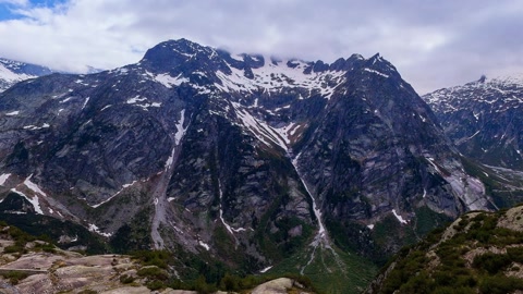 Mountain reservoir with dam walkway — Stillmotion