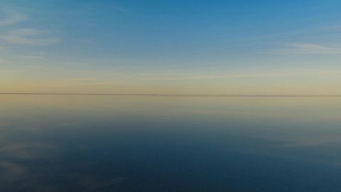 Sky over calm water at sunset — Stillmotion