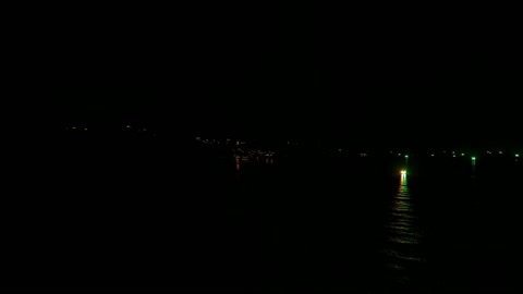 Night ocean with scattered lights — Stillmotion