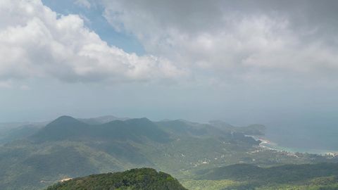 Cloudy valley with forested mountains — Stillmotion