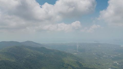Cloudy valley with forested hills — Stillmotion