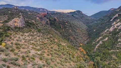 Mountain ridges under cloudy sunset skies — Stillmotion