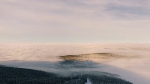 Snowy ski slope above cloud layer — Stillmotion