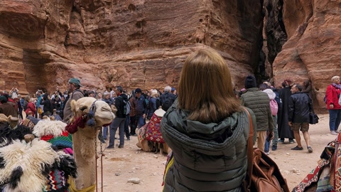 Crowds and camels in canyon ruins — Stillmotion