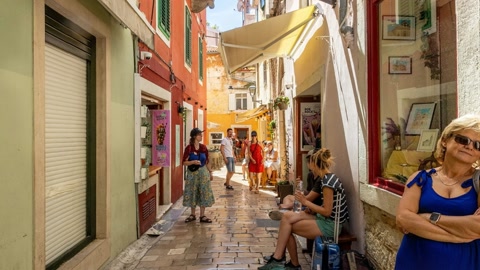Narrow alley with shopfronts and café seating — Stillmotion
