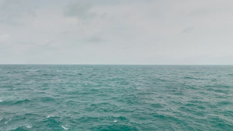 Cloudy ocean beside rocky shore — Stillmotion