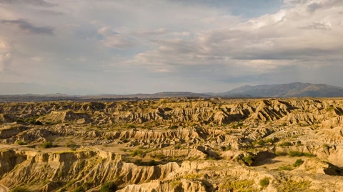 Cloudy badlands with rugged ridges — Stillmotion
