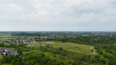 Village and river valley under cloudy skies — Stillmotion