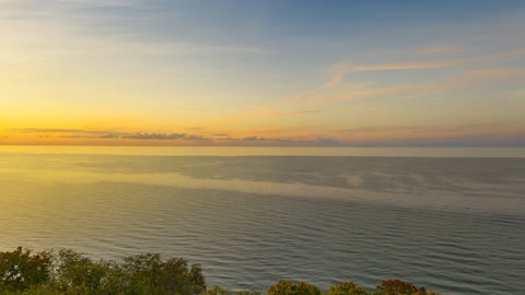 Cliffside forest overlooking calm water — Stillmotion